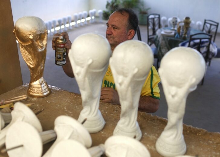 Brazilian soccer fan Jarbas Carlini makes replicas of the FIFA World Cup trophy at his home in Rio de Janeiro