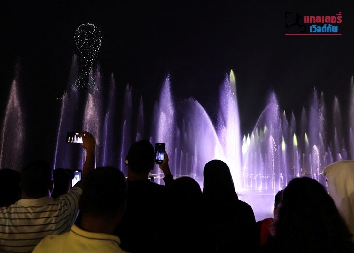 People watch fireworks and a light show on The Corniche waterfront in Doha, Qatar.