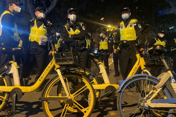 FILE PHOTO: Police officers stand guard in Shanghai