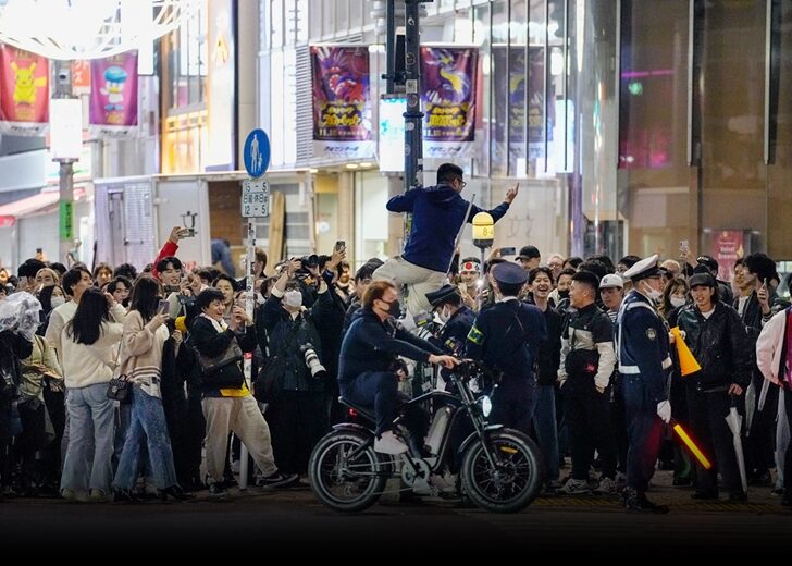 Japanese soccer fans celebrate after Japan won a FIFA World Cup Qatar 2022 match with Germany, at Shibuya crossing in Tokyo