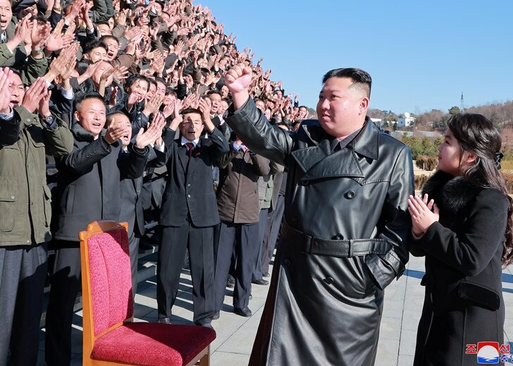 North Korean leader Kim Jong Un and his daughter attend a photo session with personnel involved in the test-fire of the Hwasong-17 intercontinental ballistic missile