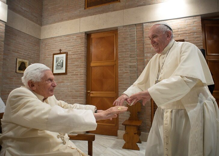FILE PHOTO: Pope Francis and Pope Emeritus Benedict XVI meet with new cardinals at the Vatican