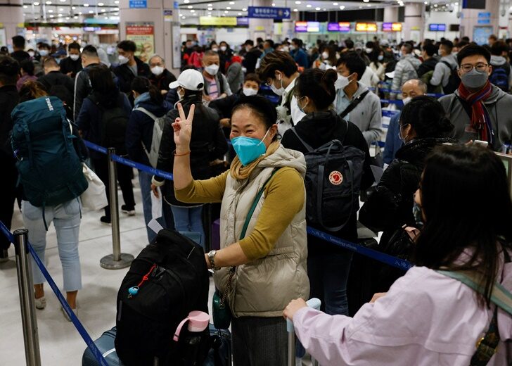A woman celebrates at Hong Kong's Lok Ma Chau border checkpoint on the first day China reopens the border amid the COVID-19 pandemic in Hong Kong