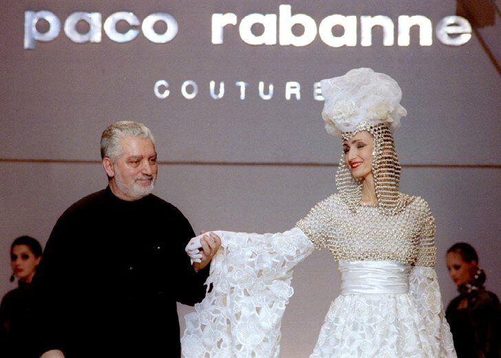 FILE PHOTO: French Fashion designer Paco Rabanne stands with one of his models at the finale of his show at the ..