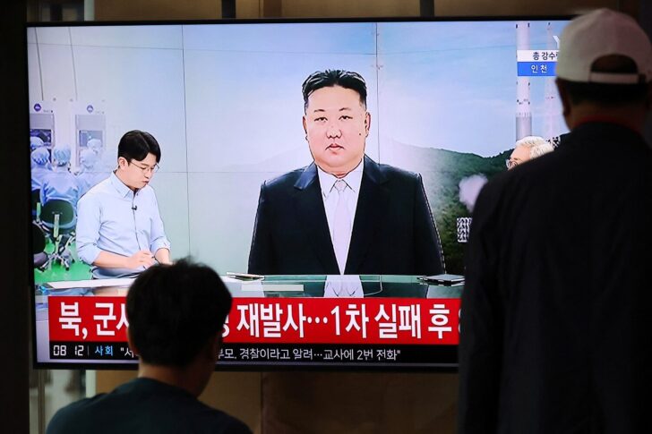 TV broadcasting a news report on North Korea firing a space rocket, at a railway station in Seoul