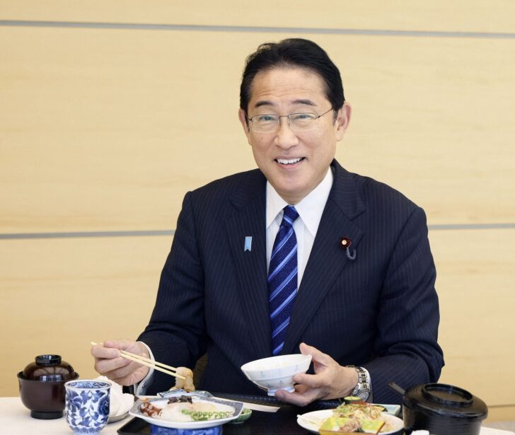 Japan's Prime Minister Fumio Kishida eats seafood from Fukushima Prefecture at a luncheon meeting, in Tokyo