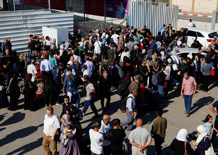 Palestinians with dual citizenship gather outside Rafah border crossing with Egypt in the hope of getting permission to leave Gaza, in the southern Gaza Strip