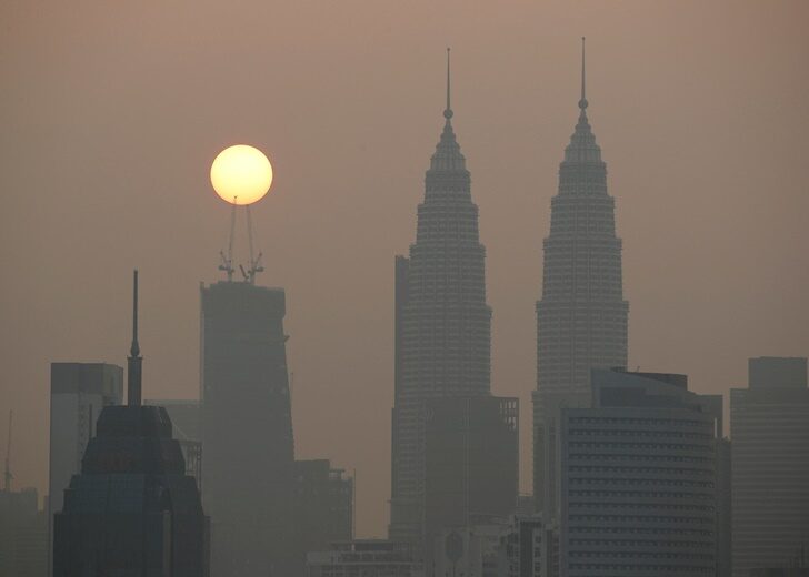 FILE PHOTO: Sun rises above Kuala Lumpur's skyline on a hazy day in Kuala Lumpur