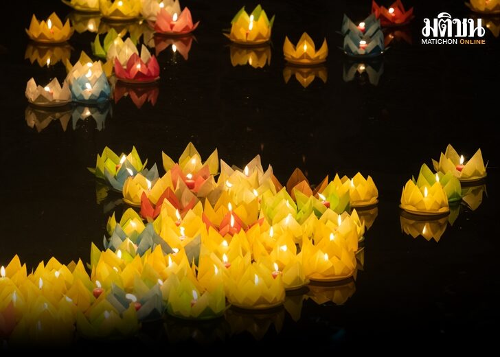 Floating colored lanterns and garlands on river at night on Vesak day in Saigon River for celebrating Buddha's birthday, that made from paper and candle. Asian culture.