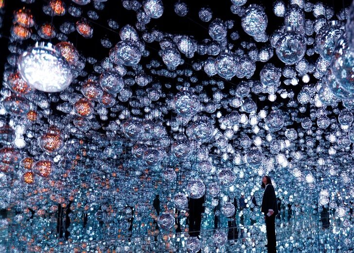 A member of the teamLab digital art group looks around an installation in preparation for the reopening of their Borderless museum in February at the Azabudai Hills complex in Tokyo