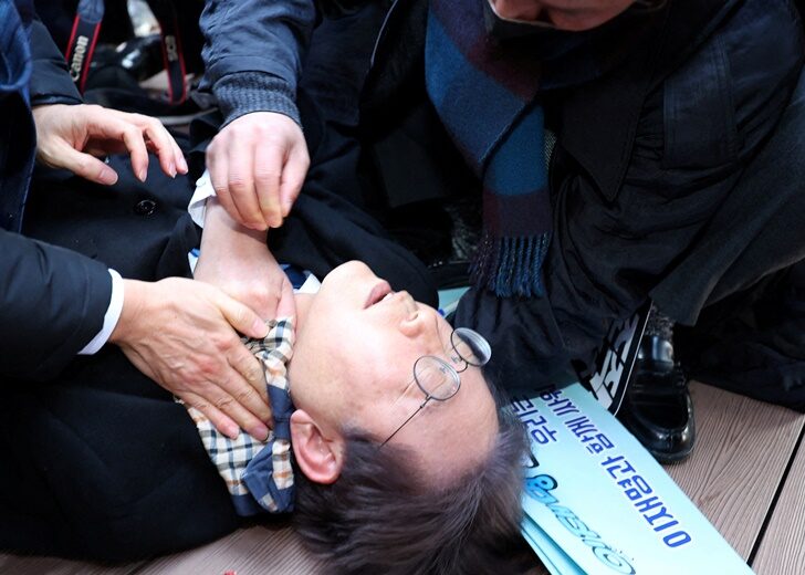 South Korea's opposition party leader Lee Jae-myung falls after being attacked by an unidentified man during his visit to Busan