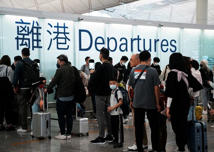FILE PHOTO: Travellers at Hong Kong International Airport