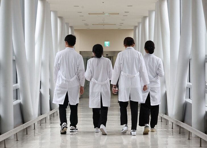 Medical workers walk at a hospital in Seoul