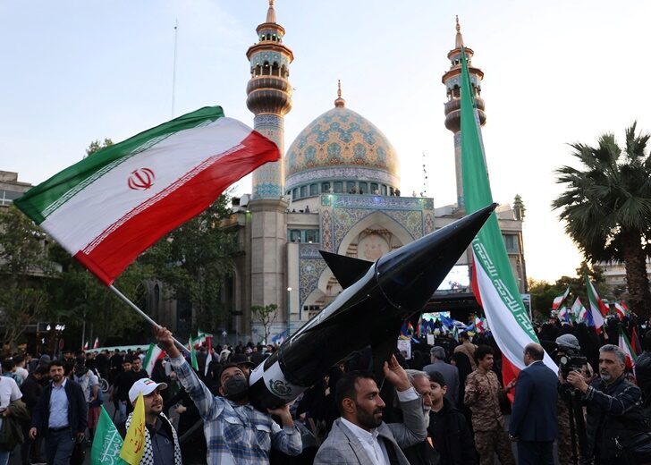 Iranians carry a model of a missile during a celebration following the IRGC attack on Israel, in Tehran