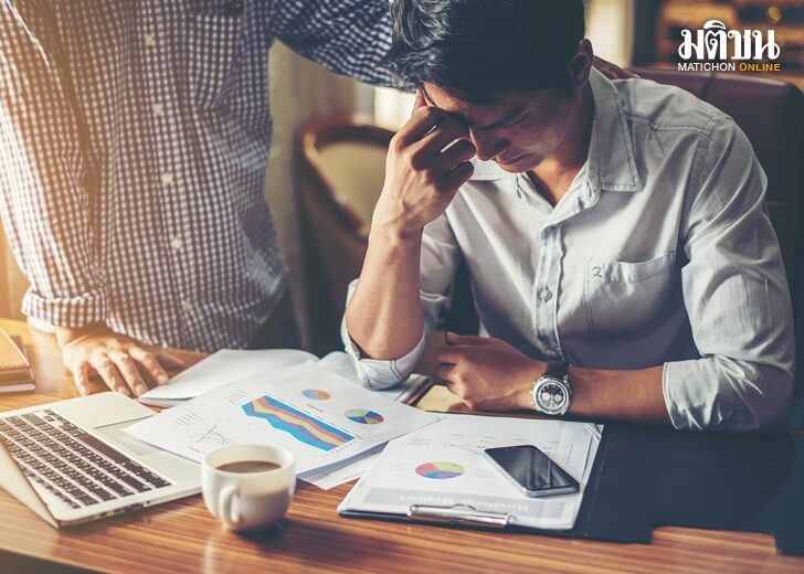 Serious young businessman looking at financial report seem like