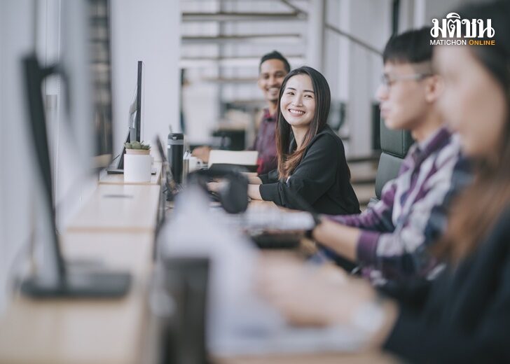 beautiful asian chinese woman smiling talking to her colleague at her workstation workplace