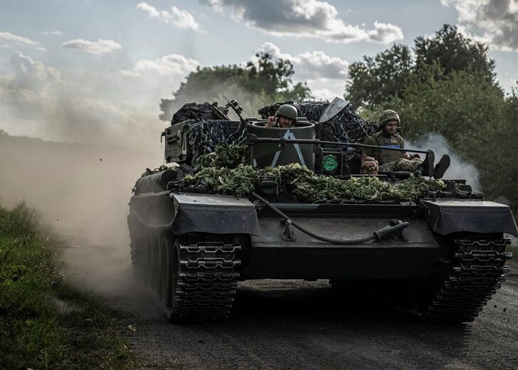 Ukrainian servicemen ride a military vehicle near the Russian border in Sumy region