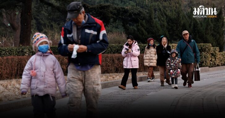 FILE PHOTO: Elderly people walk with children at a park in Beijing