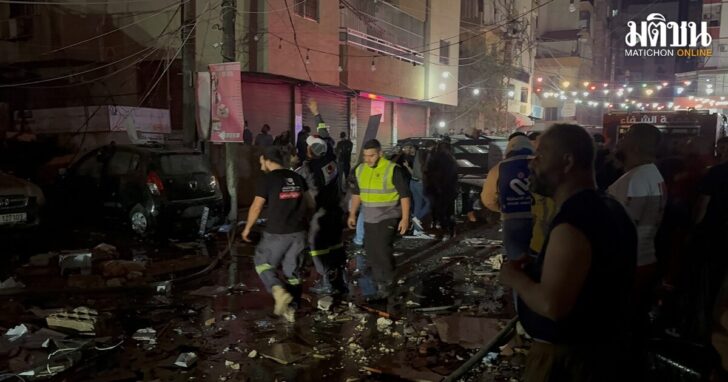 People gather near a building where a floor caught fire following an Israeli strike, in which the Israeli military said, it killed Hamas commander Hassan Farhat, in Sidon