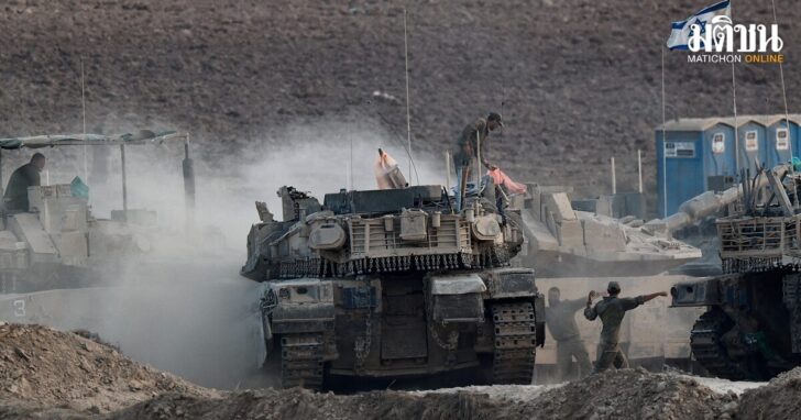 Israeli soldiers direct a tank near the Israel-Gaza border