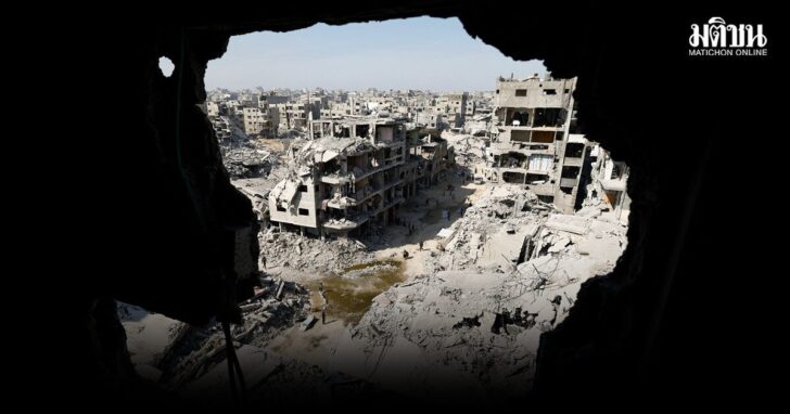 Palestinians walk past the rubble of destroyed buildings, amid a ceasefire between Israel and Hamas, in Gaza City