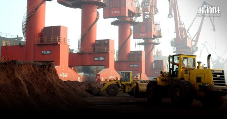 FILE PHOTO: Workers transport soil containing rare earth elements for export at a port in Lianyungang
