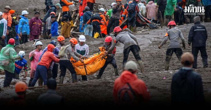 Indonesian rescue members carry a body bag containing the remains of a victim from the site of a landslide after it hit Pasirlangu village, West Bandung
