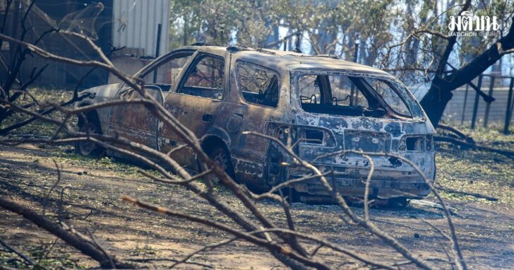 A burnt car stands at a property during a bushfire in Longwood, VIC