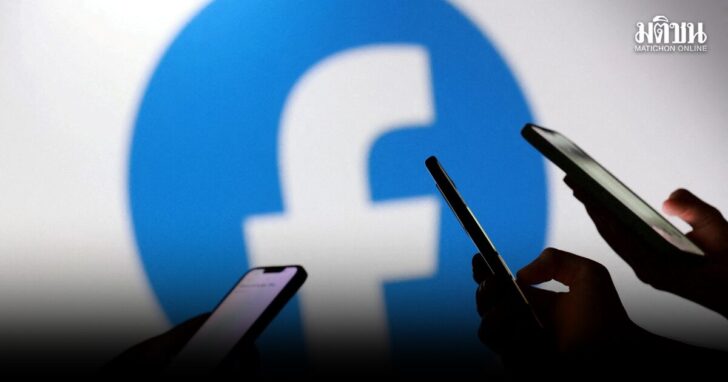 FILE PHOTO: Illustration shows teenagers pose for a photo while holding smartphones in front of a Facebook logo