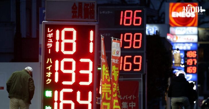 Signboards display fuel prices outside gas stations in Tokyo