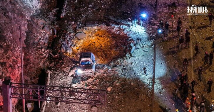 A drone view of Israeli emergency responders working at the scene of an Iranian missile strike on a road, in Jerusalem
