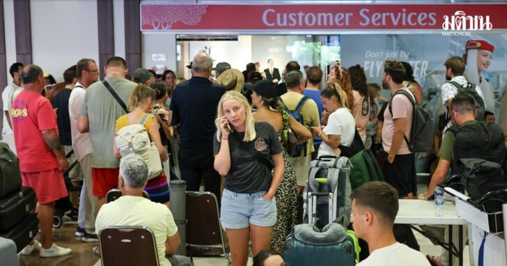 Stranded passengers wait near Emirates Airways customer service office at I Gusti Ngurah Rai International Airport after flights to Doha, Dubai, and Abu Dhabi were cancelled following strikes on Iran launched by the United States and Israel, in Kuta, Bali