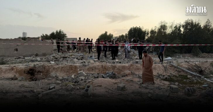 People gather at the site where rockets fired from the direction of Kuwait hit a house in Khor al-Zubair near Basra, killing multiple people, according to security and health sources, in Basra