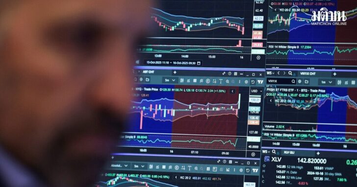 FILE PHOTO: A trader works on the floor at the New York Stock Exchange in New York City stock