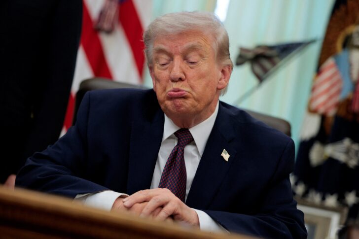 U.S. President Trump signs an executive order in the Oval Office of the White House