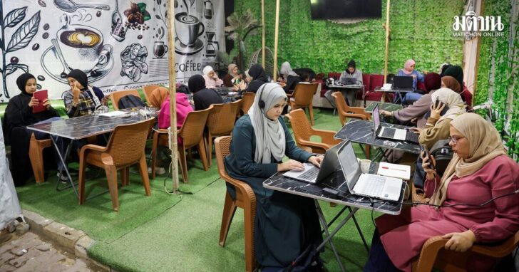 Palestinian female students study inside a cafe in Khan Younis