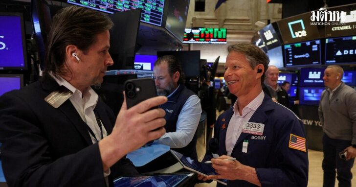 FILE PHOTO: Traders work on the floor at the New York Stock Exchange