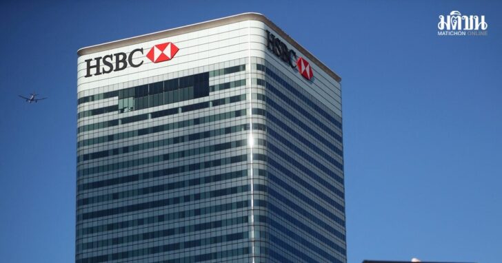 FILE PHOTO: HSBC's building in Canary Wharf is seen behind a City of London sign outside Billingsgate Market in London