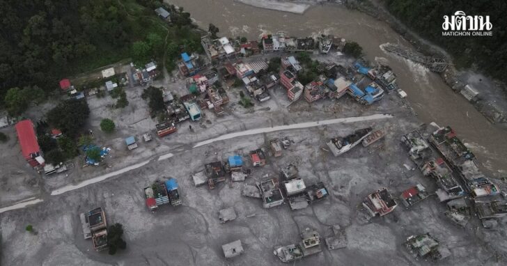 A drone view shows houses covered in mud and the broken bridge after the flash floods and mudslide, at Devighat