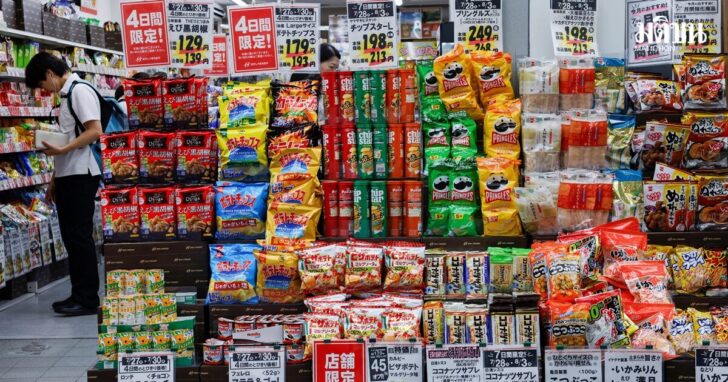 People shop for snacks at a confectionery store in Tokyo
