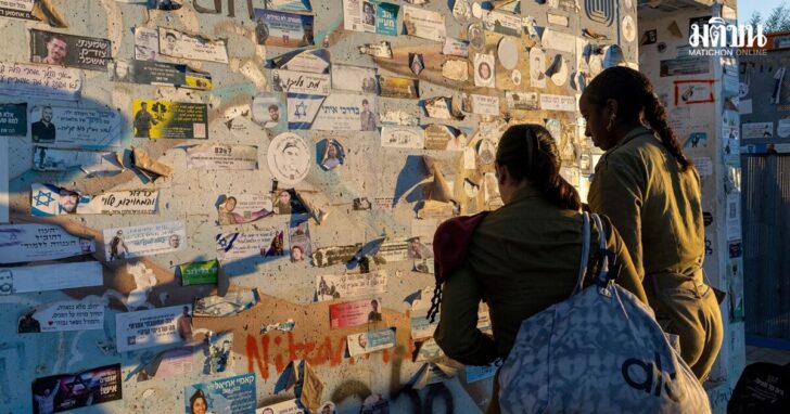 Israeli soldier place a sticker on the wall as they visit a roadside bomb shelter on the third anniversary of the deadly Hamas-led October 7 2023 attack, near Reim in southern Israel