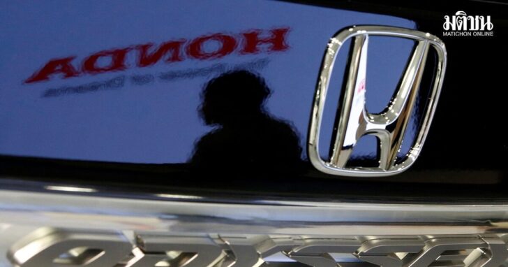 FILE PHOTO: A visitor and a logo of Honda Motor are reflected on a Honda Odyssey car at the company showroom in Tokyo