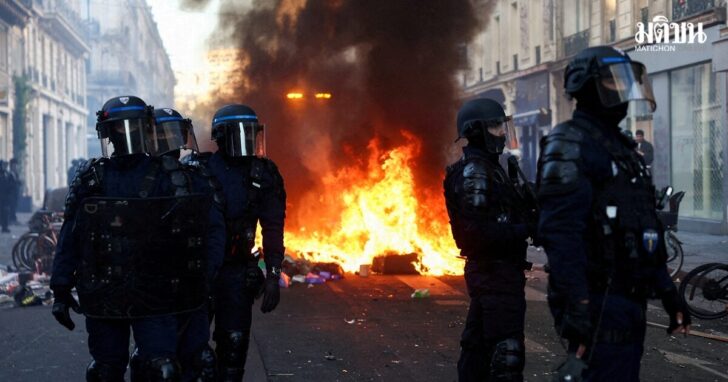 FILE PHOTO: Police officers in riot gear stand guard, the day after a national day of demonstrations against the cost of living and rising fuel prices, in Paris